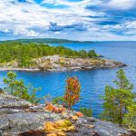 Плёночная камера на гранитном берегу среди сосен